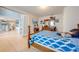 Bedroom with a wooden bed, wooden dresser, and a view into another room at 1912 Maury Rd, St Cloud, FL 34771