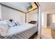 Cozy bedroom features neutral colors, canopy bed, and mounted TV at 1912 Maury Rd, St Cloud, FL 34771