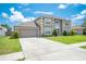 Spacious two-story home with a wide driveway, attached garage, and pristine landscaping at 1912 Maury Rd, St Cloud, FL 34771
