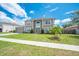 Inviting two-story home featuring lush green lawn, well-placed landscaping, and a welcoming facade at 1912 Maury Rd, St Cloud, FL 34771