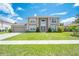 Beautiful two-story home with a well-maintained lawn, trimmed bushes and large windows at 1912 Maury Rd, St Cloud, FL 34771