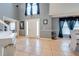 Bright foyer with high ceilings, tile floors, a white piano, and a decorative entrance door at 1912 Maury Rd, St Cloud, FL 34771
