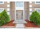 Inviting front entrance with well-maintained landscaping, including decorative rock and manicured shrubbery at 1912 Maury Rd, St Cloud, FL 34771