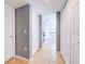 Hallway with tile flooring leads to the kitchen with white cabinets and appliances at 1912 Maury Rd, St Cloud, FL 34771