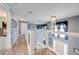 Upstairs hallway features wood-look flooring, staircase with modern lighting fixture at 1912 Maury Rd, St Cloud, FL 34771