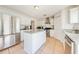 Well-lit kitchen featuring white cabinets, stainless steel appliances, and a center island with granite countertops at 1912 Maury Rd, St Cloud, FL 34771