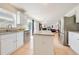 Bright kitchen with stainless steel appliances, white cabinetry and granite countertops, open to the living area at 1912 Maury Rd, St Cloud, FL 34771