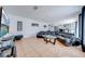 Spacious living room featuring tile floors and a large black leather sectional sofa with a glass table at 1912 Maury Rd, St Cloud, FL 34771