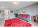Upstairs living room featuring gray sofa, colorful decor, and modern flooring at 1912 Maury Rd, St Cloud, FL 34771