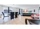 Open-concept living and dining area with black leather furniture and neutral tones at 1912 Maury Rd, St Cloud, FL 34771