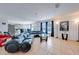 Open-concept living area with tile floors, sectional seating, modern decor, and an adjoining kitchen at 1912 Maury Rd, St Cloud, FL 34771