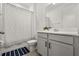 Bright bathroom featuring modern sink, vanity, mirror, toilet, and shower with curtain at 19267 Allium Pl, Orlando, FL 32827