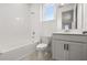 Well-lit bathroom featuring white tile, a soaking tub, and modern vanity at 19267 Allium Pl, Orlando, FL 32827