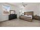 Well-lit bedroom with a large window, neutral-toned carpet, and ceiling fan at 19267 Allium Pl, Orlando, FL 32827