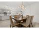 View of the dining room and kitchen featuring pendant lighting and dining table with seating for six at 19267 Allium Pl, Orlando, FL 32827