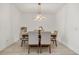 Modern dining room with a contemporary chandelier and seating for six at 19267 Allium Pl, Orlando, FL 32827