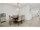 View of the dining room featuring hardwood floors, a dining table with seating for six, and modern lighting at 19267 Allium Pl, Orlando, FL 32827