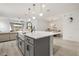 View of the kitchen island featuring modern pendant lighting, sink, faucet, and hardwood floors at 19267 Allium Pl, Orlando, FL 32827