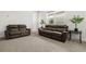 Comfortable living room featuring two sofas, carpet, and a well-lit, open space at 19267 Allium Pl, Orlando, FL 32827