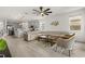 View of the open concept living room featuring hardwood floors, large sofa, and a ceiling fan at 19267 Allium Pl, Orlando, FL 32827