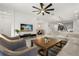 View of the open concept living room featuring a large sofa, chairs, and adjacent kitchen and dining area at 19267 Allium Pl, Orlando, FL 32827
