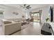 Bright living room with neutral decor, wood floors, and sliding glass doors to the backyard at 19267 Allium Pl, Orlando, FL 32827