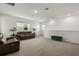 Expansive loft area featuring dual sofas, a carpeted floor, and natural light from windows at 19267 Allium Pl, Orlando, FL 32827