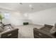 Spacious loft area with plush carpeting, sofas, and natural light from a window at 19267 Allium Pl, Orlando, FL 32827