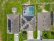 Aerial view of homes with solar panels and a screened pool at 209 Willow Bend Dr, Davenport, FL 33897