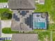 Aerial view of a home with solar panels and a screened pool area at 209 Willow Bend Dr, Davenport, FL 33897