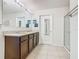 Bathroom with double vanity, granite countertops, ample cabinet space, and glass shower at 209 Willow Bend Dr, Davenport, FL 33897