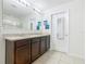 Bathroom with double vanity, granite countertops, ample cabinet space, and glass shower at 209 Willow Bend Dr, Davenport, FL 33897
