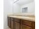 Bathroom featuring double sinks with a large mirror and a neutral-toned countertop at 209 Willow Bend Dr, Davenport, FL 33897