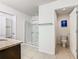 Bright bathroom featuring a glass shower, granite countertop, and separate toilet room at 209 Willow Bend Dr, Davenport, FL 33897