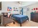This cozy bedroom includes a desk, dresser, and bed, perfect for relaxing or studying at 209 Willow Bend Dr, Davenport, FL 33897