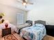 Bedroom with twin beds, ceiling fan, and natural light from the window at 209 Willow Bend Dr, Davenport, FL 33897