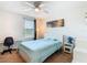 Bright bedroom features a desk area, a ceiling fan, and ample natural light at 209 Willow Bend Dr, Davenport, FL 33897