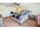 Spacious bedroom featuring a ceiling fan, desk, and modern furniture at 209 Willow Bend Dr, Davenport, FL 33897