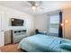 This bedroom features a queen-size bed, carpet flooring, and a large window for natural light at 209 Willow Bend Dr, Davenport, FL 33897