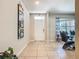 Open foyer with tile flooring, white front door, and adjacent dining area at 209 Willow Bend Dr, Davenport, FL 33897