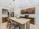 Gourmet kitchen featuring granite countertops, stainless steel appliances, island with seating at 209 Willow Bend Dr, Davenport, FL 33897
