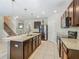 Spacious kitchen with granite countertops, stainless steel appliances, and open access to the staircase at 209 Willow Bend Dr, Davenport, FL 33897