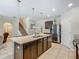Modern kitchen featuring island, granite counters, stainless steel appliances, and stairs to second floor at 209 Willow Bend Dr, Davenport, FL 33897