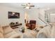 Cozy living room with comfortable seating, a ceiling fan, and a large television at 209 Willow Bend Dr, Davenport, FL 33897