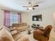 Inviting living room featuring plush sofas, a glass coffee table, and a large television at 209 Willow Bend Dr, Davenport, FL 33897