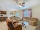 Open living space with plush seating, a ceiling fan, and a view into the dining area at 209 Willow Bend Dr, Davenport, FL 33897