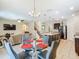 Open-concept living space with kitchen, dining, and living areas, and a staircase at 209 Willow Bend Dr, Davenport, FL 33897