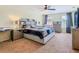 This main bedroom features soft carpet, a bed, dressers, and soft lighting at 209 Willow Bend Dr, Davenport, FL 33897