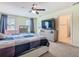 This main bedroom includes windows, a ceiling fan, and leads to the ensuite bathroom at 209 Willow Bend Dr, Davenport, FL 33897