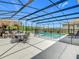 An inviting outdoor space features a pool, spa, outdoor kitchen, and plenty of space for dining or lounging at 209 Willow Bend Dr, Davenport, FL 33897